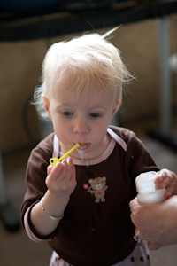 Adria munching on the bubble wand