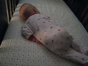 Adria asleep on her arms