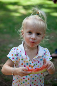 Adria eating a slice of watermelon