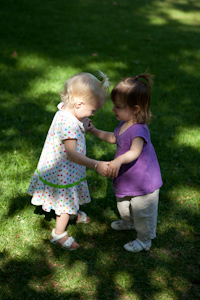 Adria and Penny dancing in the grass