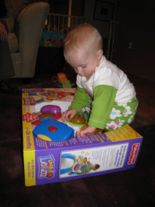 Adria sitting on top of her new toy, playing