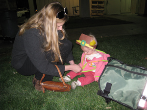 Amanda putting Adria's pilgram hat on her