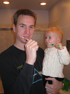 Adria brushing her teeth with Amanda's toothbrush