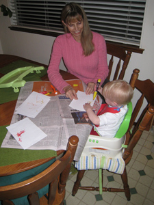 Janet helping Adria color with markers at the kitchen table Janet helping Adria color with markers at the kitchen table