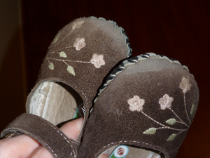 Worn toes of Adria's shoes