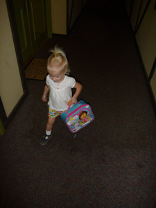 Adria carrying her Dora lunchbox