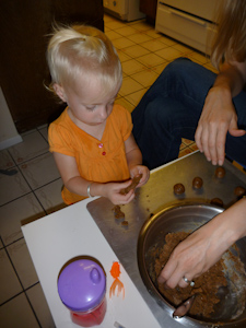 Adria trying to fashion a cookie ball Adria trying to fashion a cookie ball