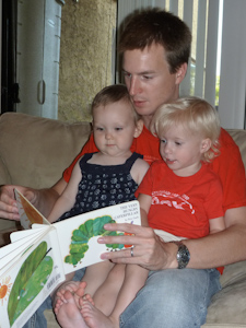 Drew reading a book to both girls Drew reading a book to both girls