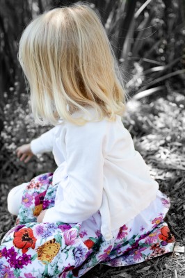 Artsy edit of Adria sitting among the flowers