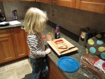 Adria fixing her own PB&J sandwich