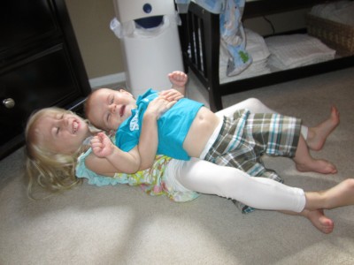 Adria and Austin wrestling on the floor: it begins