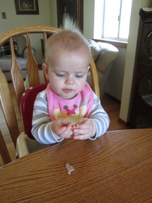 Eating some bits of pita, blissfully unaware of the pink bib